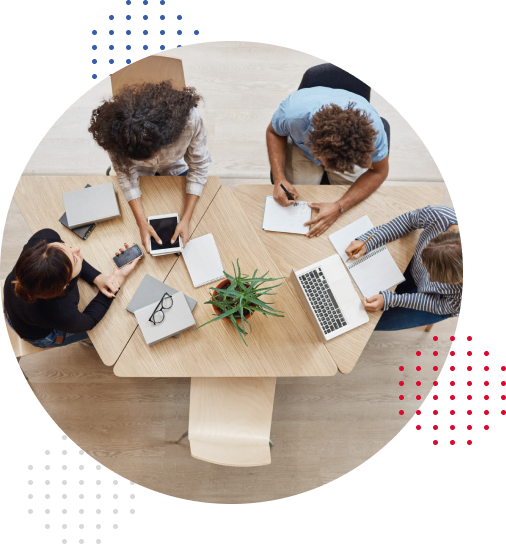 Image of four people working as a team around a table in overhead shot